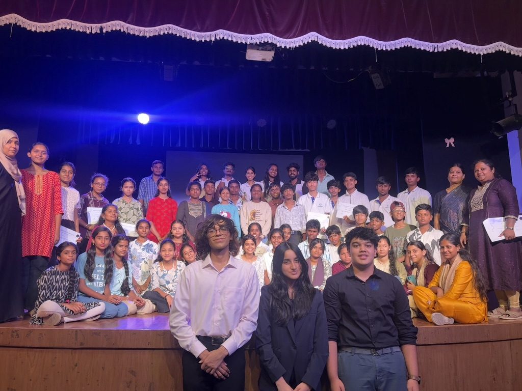 Students holding certificates on stage after a RE:Present Bharat youth parliament