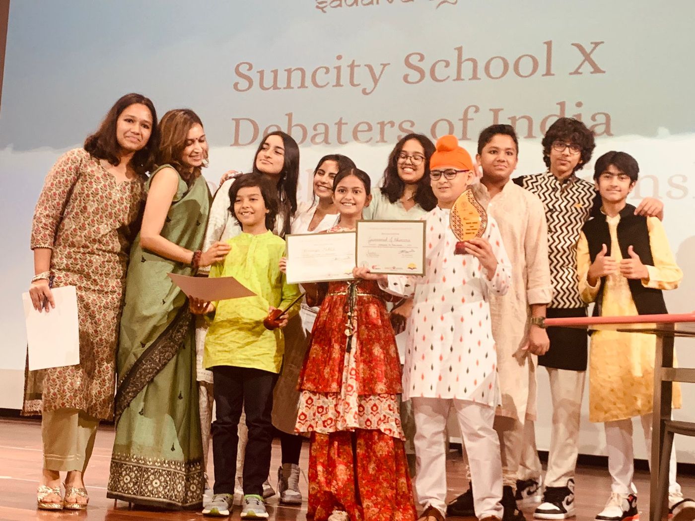 Winners and organizers on stage at the Suncity School and Debaters of India championship, 2023