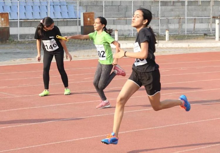 A relay baton handoff on the track