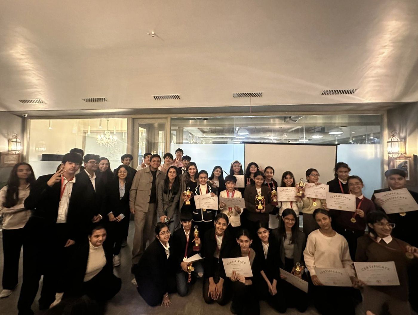 Winners and organizers with trophies and certificates at the Debaters of India WSDC Championship, 2025